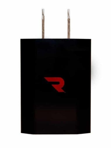 A black shopping bag with two brown paper handles and a red "R" logo on the front.