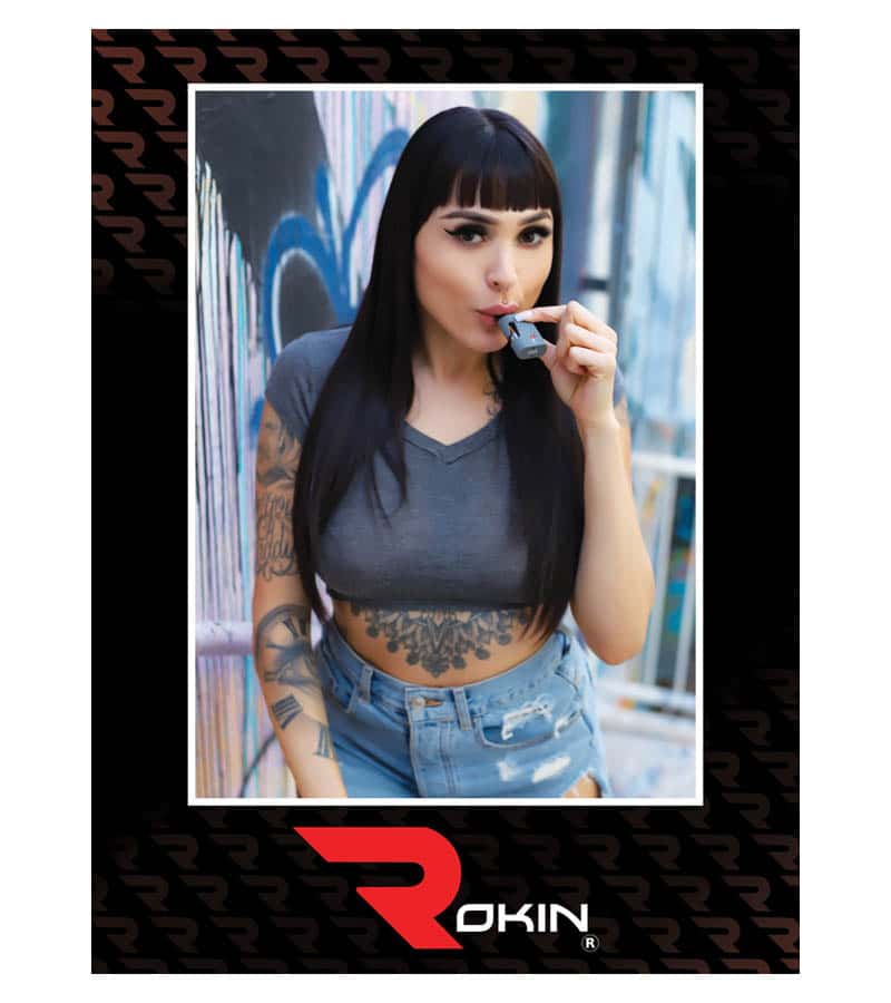 Rage Poster A woman with dark hair and tattoos on her arms and torso holds a gray vape to her mouth; "ROKIN" is at the bottom.