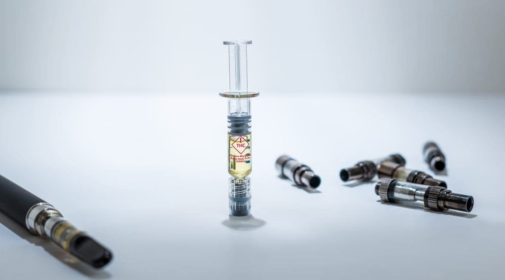 A,Thc,Distillate,Syringe,Standing,Upright,,In,The,Middle,Of syringe filled with distillate