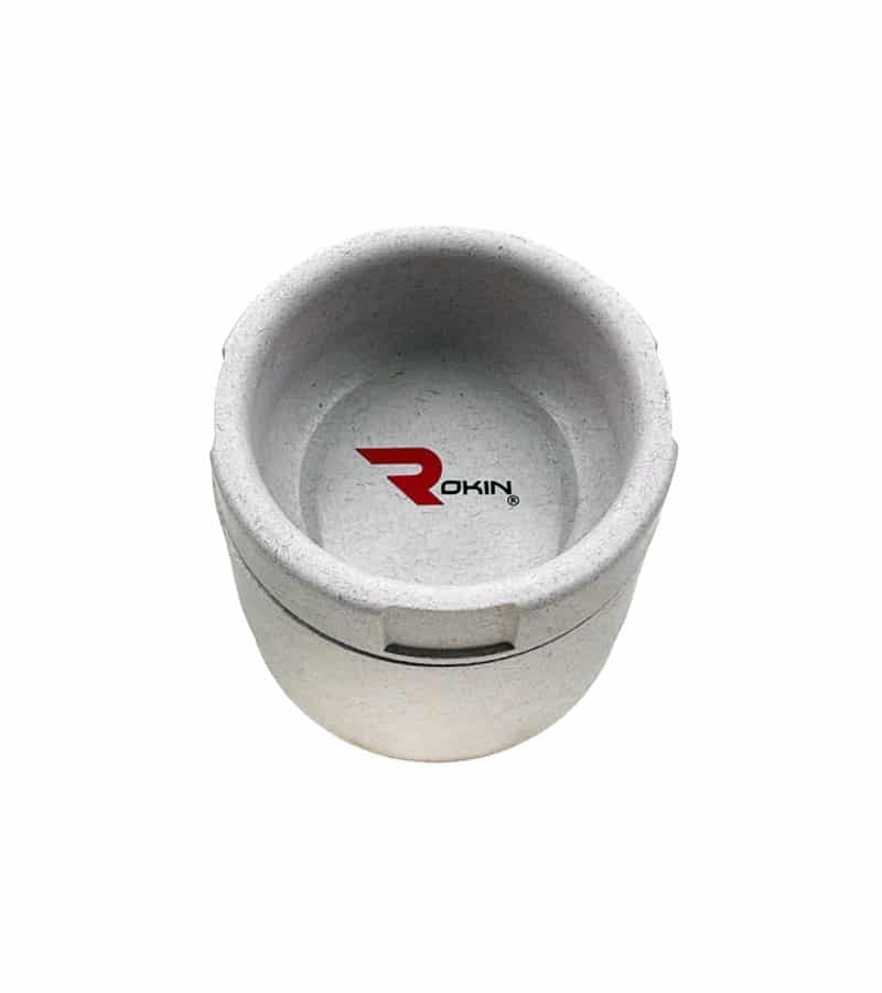 Grynder---top--cement A light gray, textured pet bowl with a red "ROKIN" logo on the bottom, viewed from above.